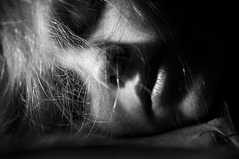 Artistic black and white close-up of sleeping woman's face