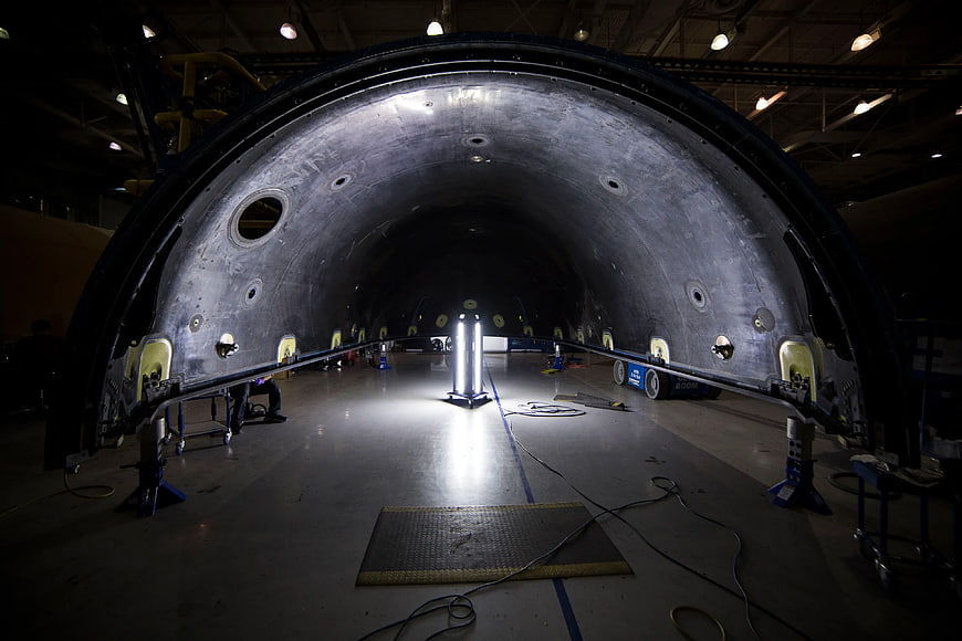 Interior of rocket fuselage under construction in assembly hangar