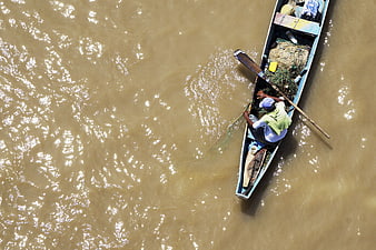 Aerial view of fisherman in boat on river