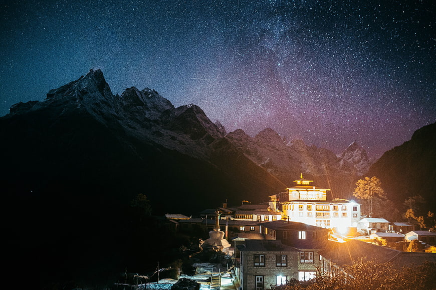Night Sky with Stars Over Mountain Village and Temple