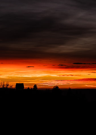 Dramatic Sunset Silhouette of House and Trees