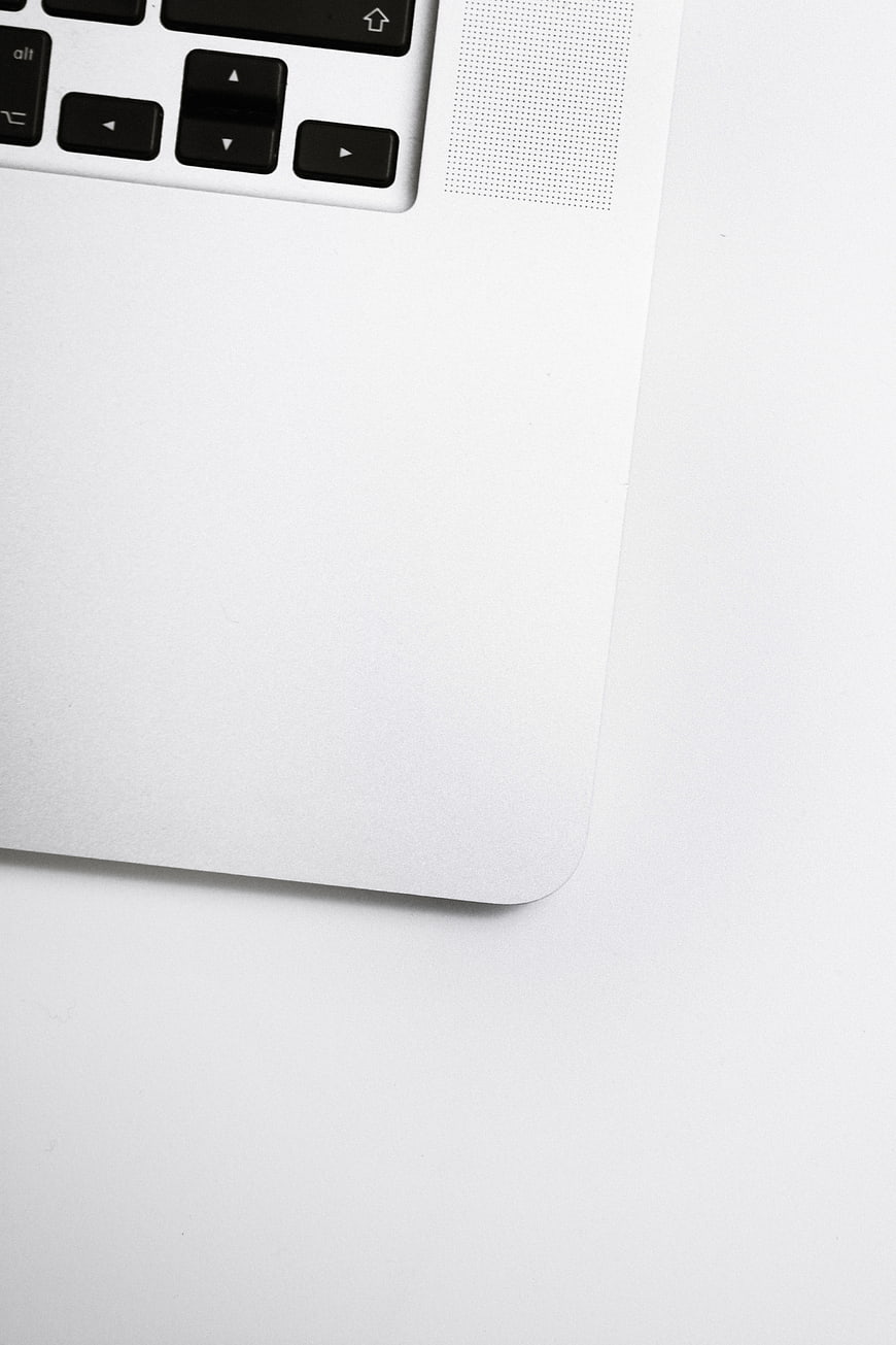 Minimalist White Laptop Corner with Keyboard and Copyspace