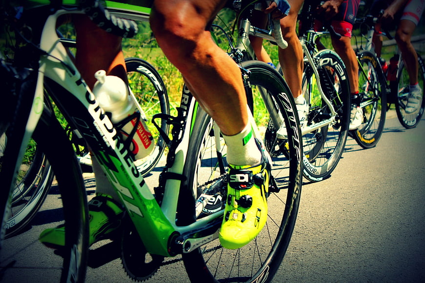 Close-up of cyclists legs and road bikes in motion