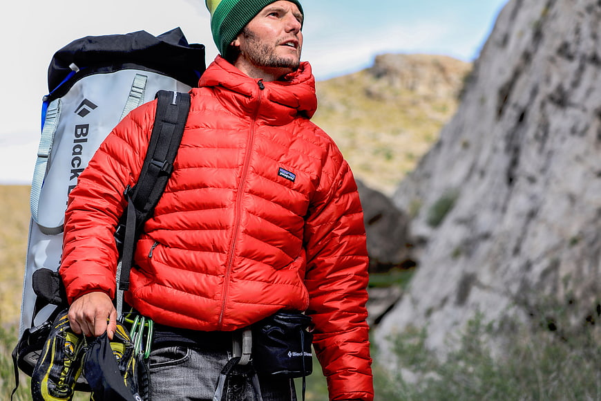 Male Rock Climber in Red Jacket with Backpack