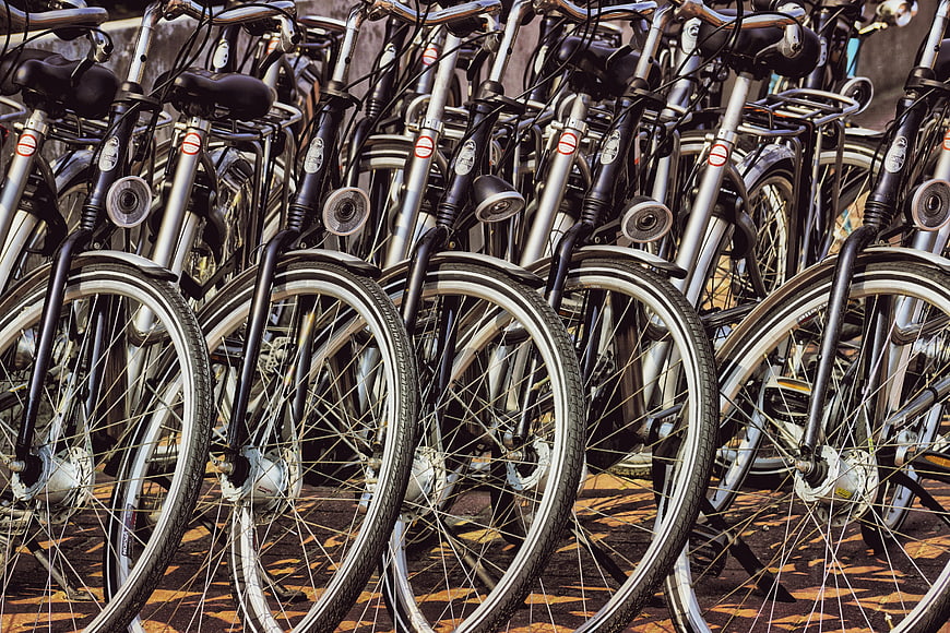 Row of Rental Bicycles Parked in Urban Setting