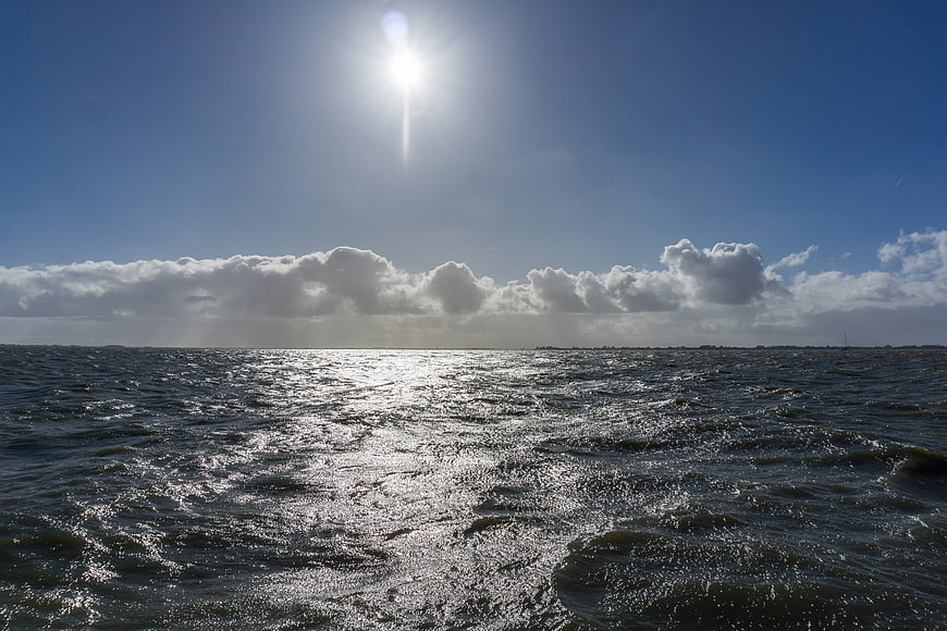 Sunlight Reflecting on Choppy Sea Surface with Clouds