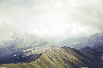 Misty Mountain Ridge Landscape with Cloudy Sky