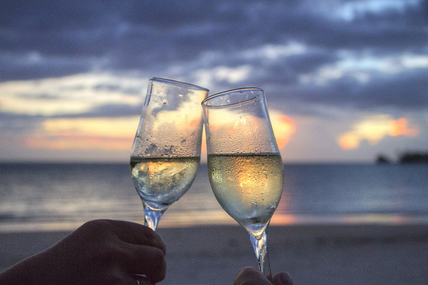 Champagne Toast on Beach at Sunset