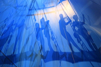 Blue Silhouettes of Circus Performers on Trapeze