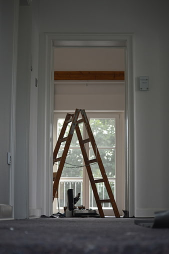 Wooden Stepladder In Home Renovation Room With Natural Window Light