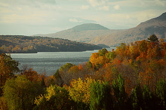 Scenic autumn landscape with lake and colorful mountains
