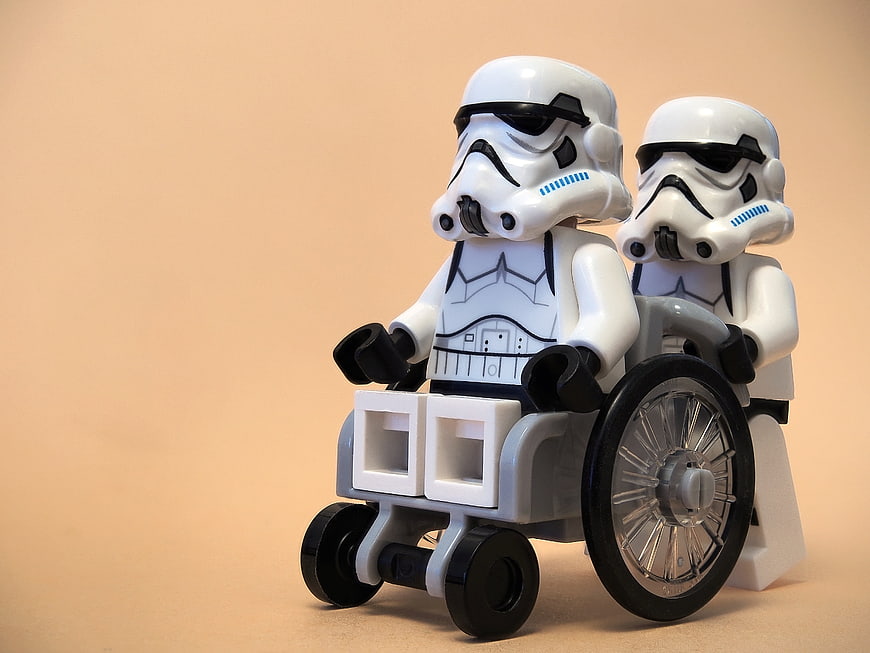 Lego Stormtroopers in Wheelchair on Orange Background