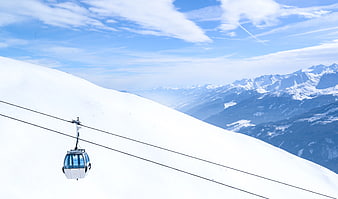 White Cable Car on Snowy Mountain Slope