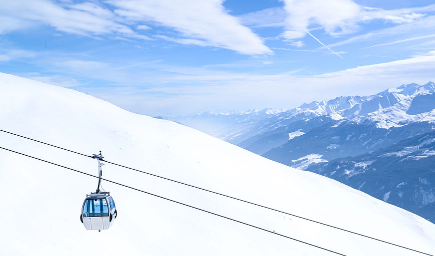 White Cable Car on Snowy Mountain Slope