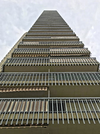 Low angle view of tall apartment building with balconies