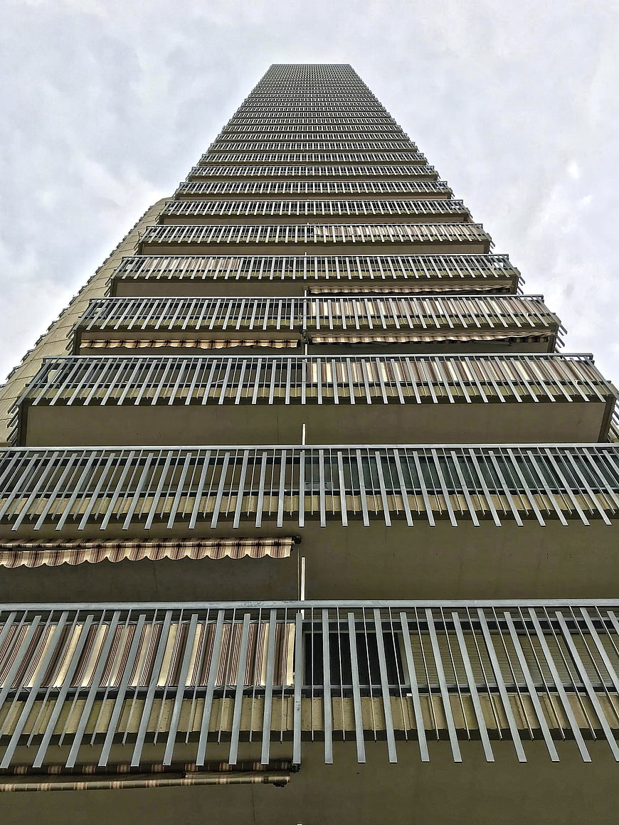 Low angle view of tall apartment building with balconies