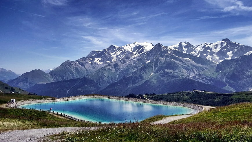 Alpine reservoir with turquoise water and snow-capped mountains
