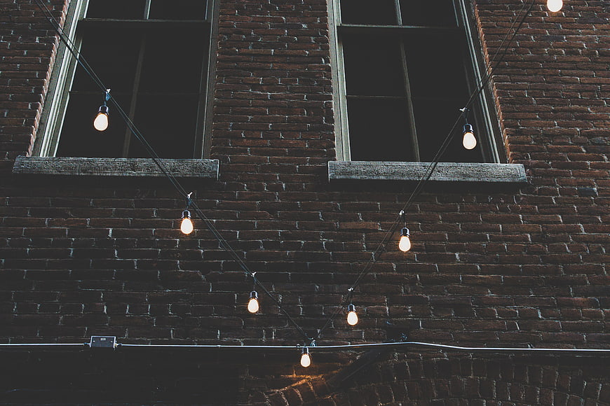 String Lights on Brick Wall with Windows
