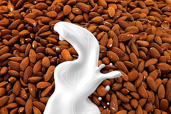 Dynamic Splash of White Almond Milk on Brown Almonds
