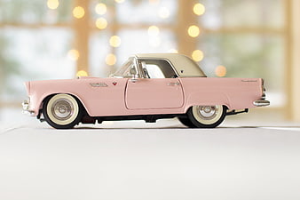 Pink Vintage Thunderbird Model Car with Bokeh Background