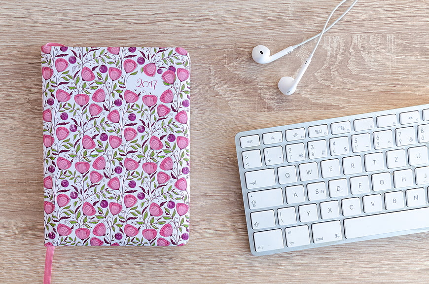 Floral 2017 Planner, Keyboard, and Earphones on Wooden Desk