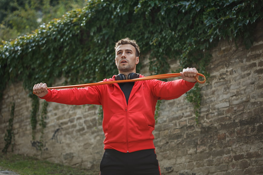 Man Exercising with Resistance Band Outdoors