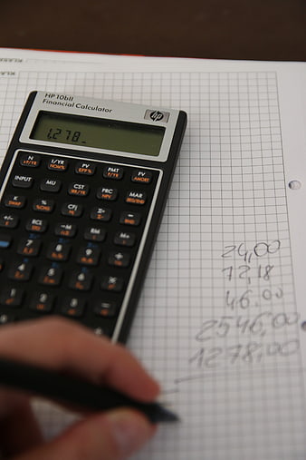 Financial calculator on graph paper with handwritten calculations