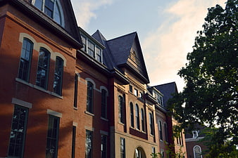 Historic Red Brick University Building Exterior With Arched Windows