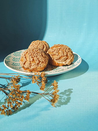 Crispy pastries on blue plate with dried flowers