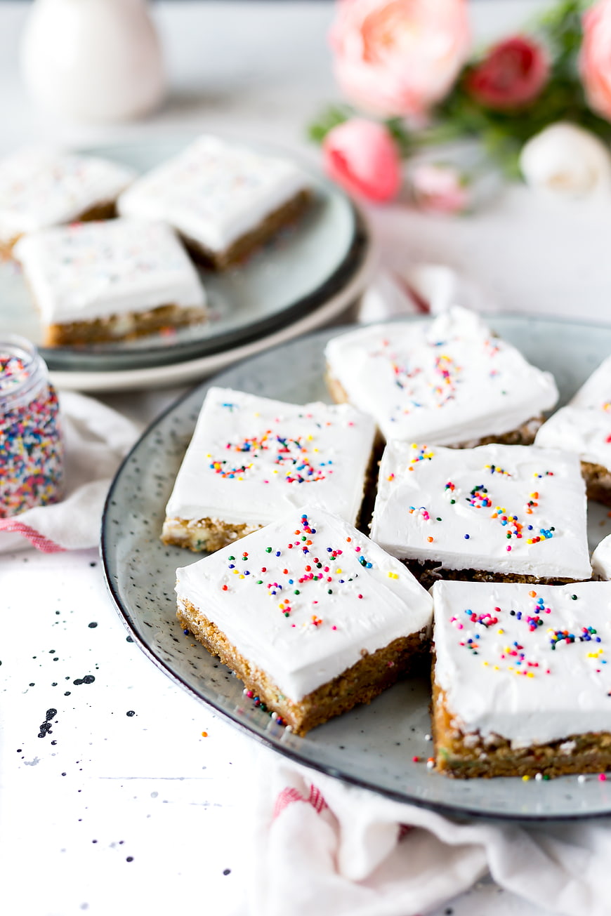 Frosted Cake Squares with Sprinkles on a Plate