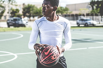 Athletic Man Holding Basketball on Outdoor Court