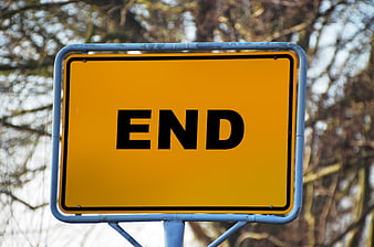 Yellow road sign with the word END in black letters