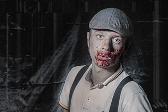 Scary Zombie Man in Vintage Costume with Fake Blood