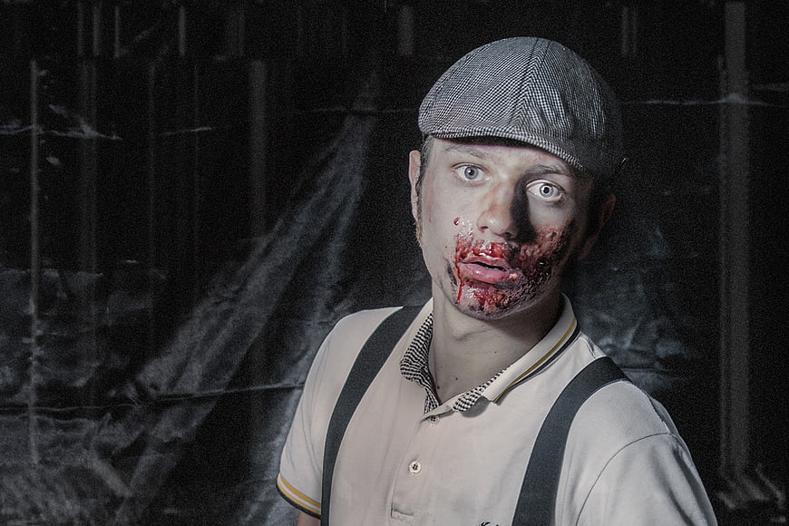 Scary Zombie Man in Vintage Costume with Fake Blood