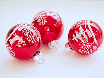 Red Christmas Ornaments with White Snowflake Patterns on White Background