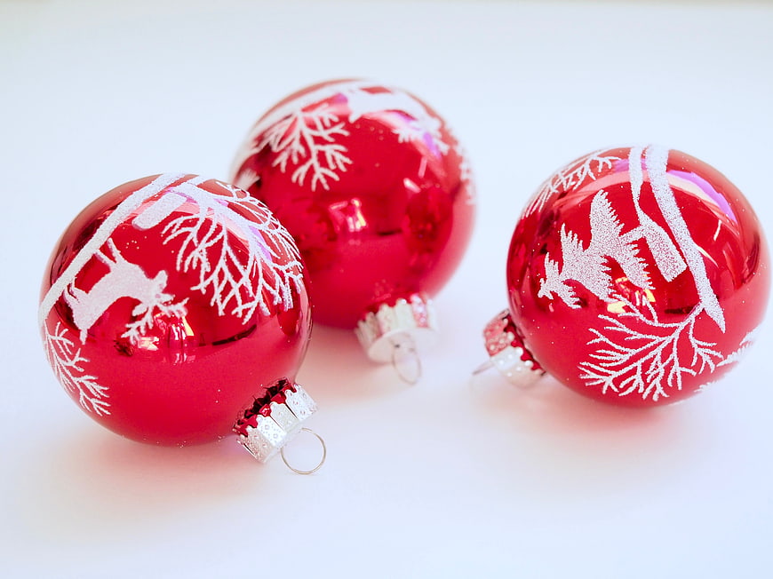 Red Christmas Ornaments with White Snowflake Patterns on White Background