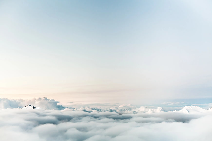 Snowy Mountain Peaks Above Sea of Clouds
