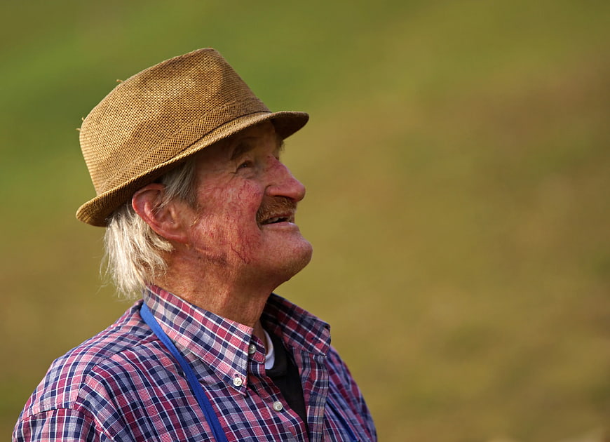 Senior Man in Straw Hat Looking Up Outdoors
