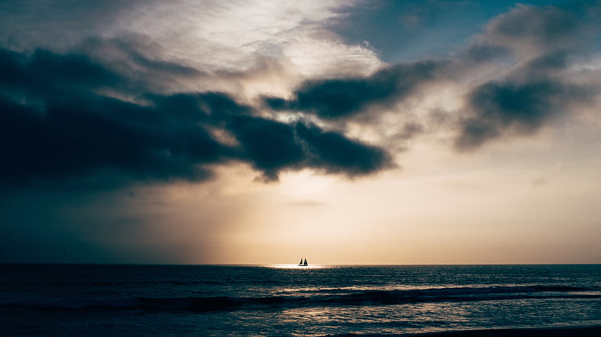 Dramatic Sunset Sailboat Silhouette on Ocean Horizon
