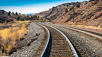Curved Railway Tracks Winding Through Arid Mountain Landscape
