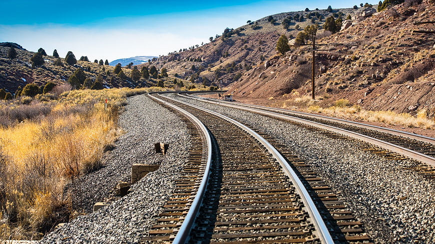 Curved Railway Tracks Winding Through Arid Mountain Landscape