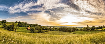 Panoramic Summer Meadow Landscape With Wooden Barn And Dramatic Sunset Sky
