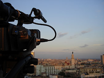 Professional Video Camera Filming Havana Cityscape at Dusk