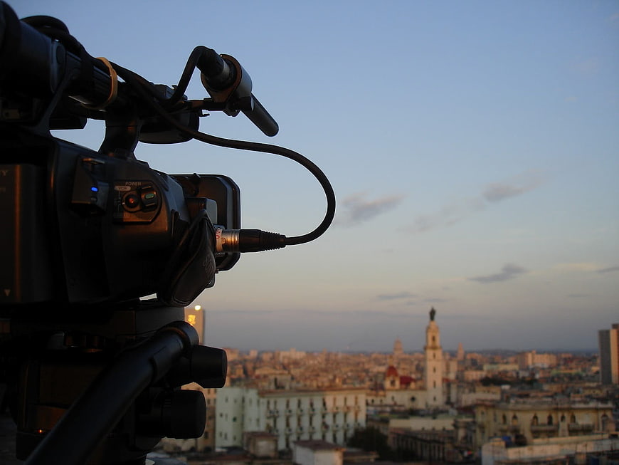 Professional Video Camera Filming Havana Cityscape at Dusk