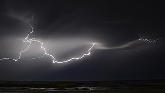 Dramatic Lightning Strike Over Dark Ocean At Night