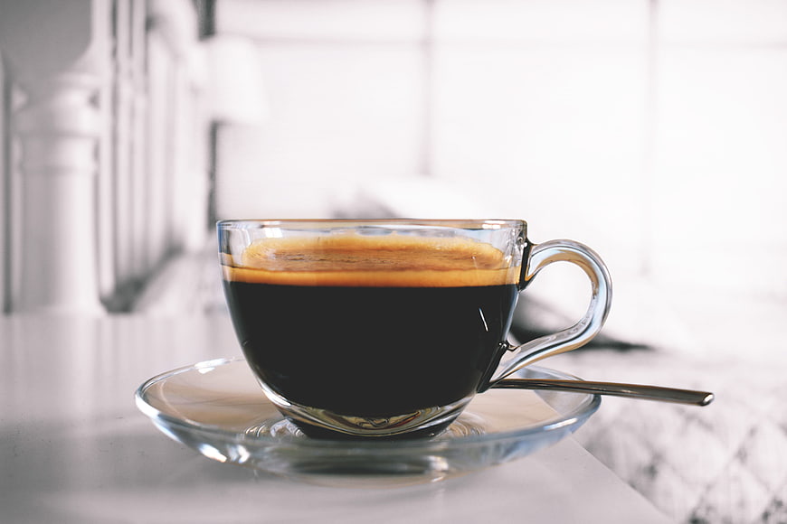 Black Coffee in Clear Glass Cup on Marble Table