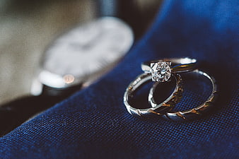Wedding Rings and Watch on Blue Suit Fabric