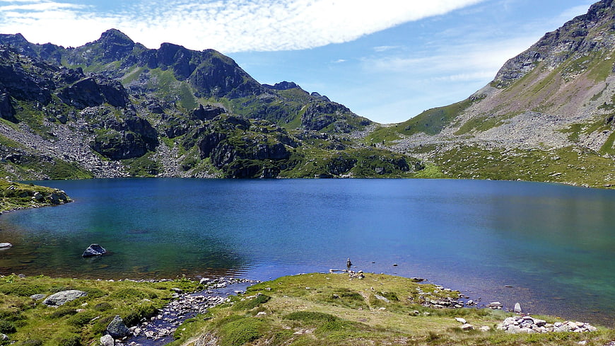 Serene Alpine Lake Surrounded by Rugged Mountains