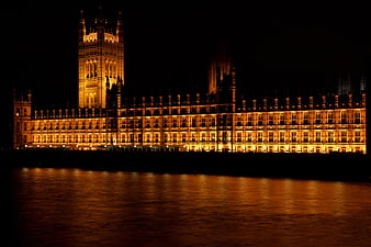 Palace of Westminster illuminated at night with river reflection