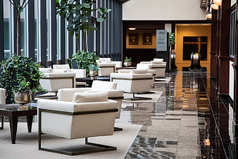 Modern Hotel Lobby Interior With White Armchairs And Polished Marble Floor